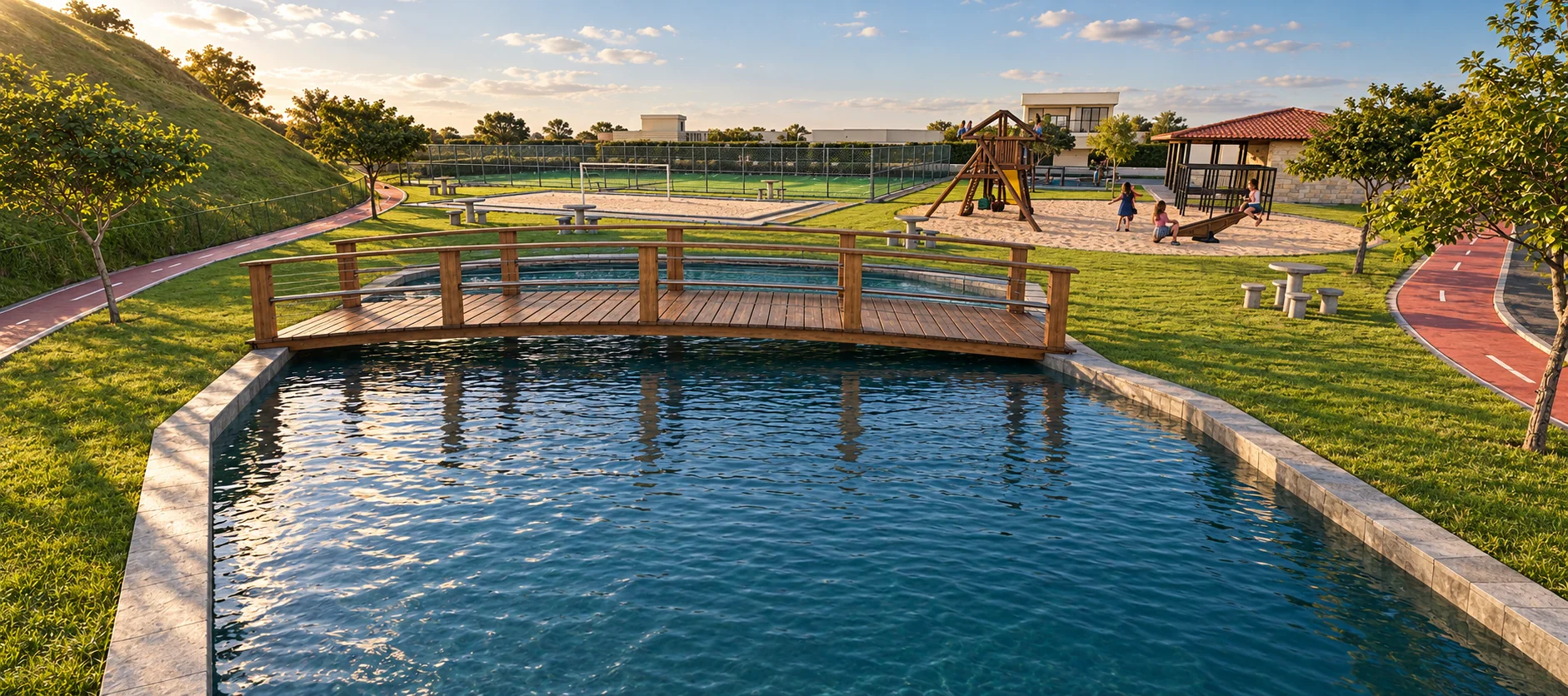 Lago com ponte de madeira, com playground e quadras ao fundo